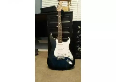 Midnight/navy blue electric guitar, small amp